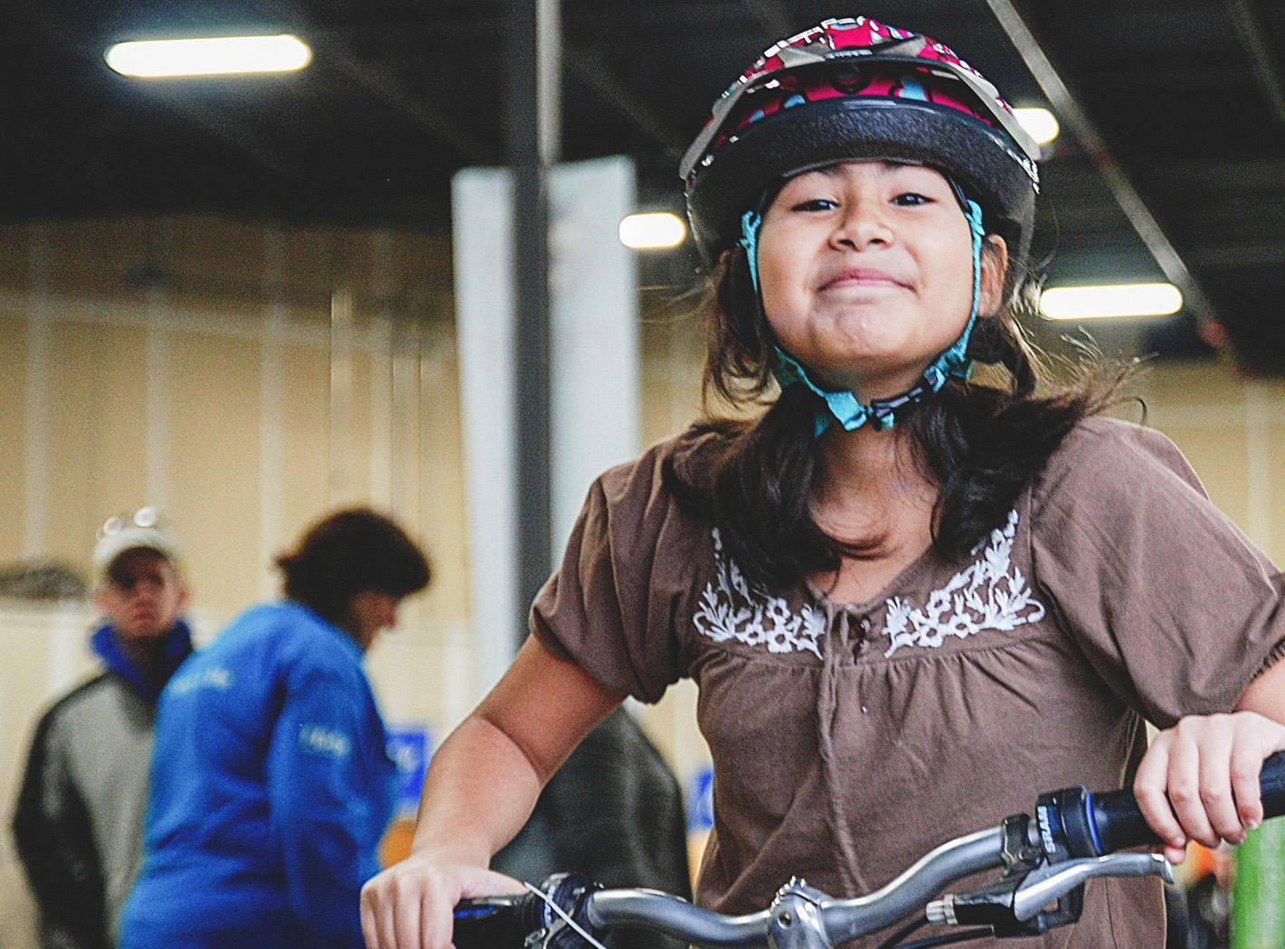 Girl on bike with helmet Free Bikes 4 Kidz Detroit