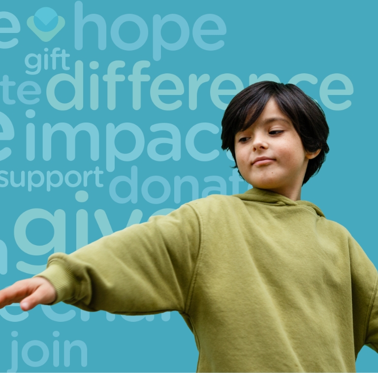 A child in a green sweatshirt stands against a blue background with words like “hope,” “difference,” “impact,” and “give” in large text behind them. The child’s arm is outstretched and they appear to be smiling slightly.